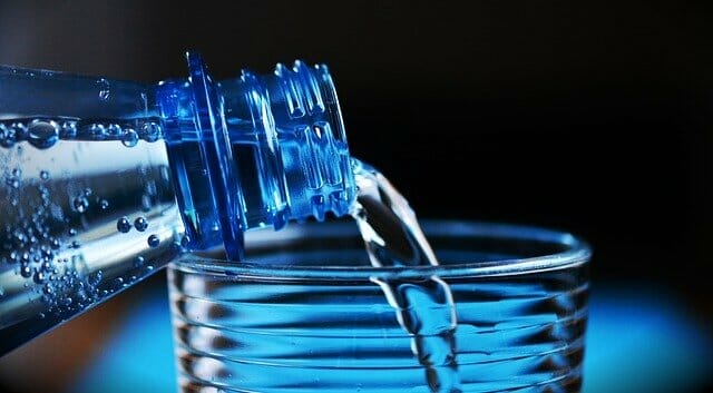 woda nalewana z butelki do szklanki
